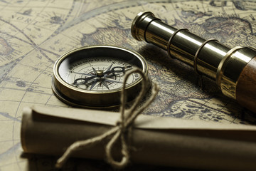 Retro compass with old map and spyglass