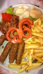 Serving kebabs with French fries