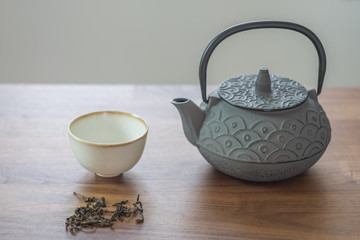 Image of traditional eastern teapot and teacups on wooden desk 