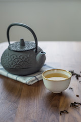 Image of traditional eastern teapot and teacups on wooden desk 