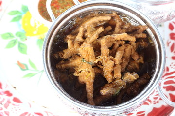 Boiled chicken foots with spice herb soup in stainless metal silver pot in big plate for Catering, local urban food of asian and chinese