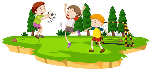 Obraz na płótnie Canvas Boys playing soccer in the field