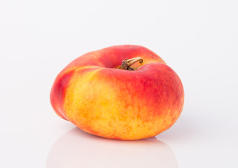 flat peaches (donut peaches) on a background