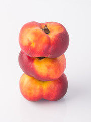 flat peaches (donut peaches) on a background