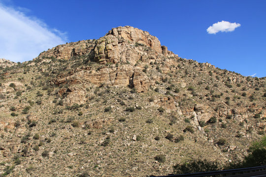 Rocky hillside along the road going up Mount Lemmon in Tucson, Arizona, USA in the Santa Catalina Mountains located in the Coronado National Forest with blue sky copy space.
