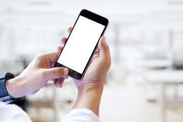 Mock up smartphone blank screen in man hands in blurred office interior background.