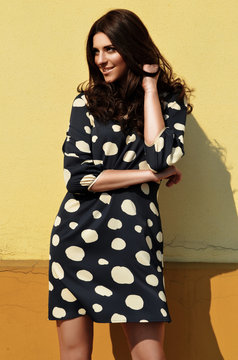 Smiling young woman in polka dot dress