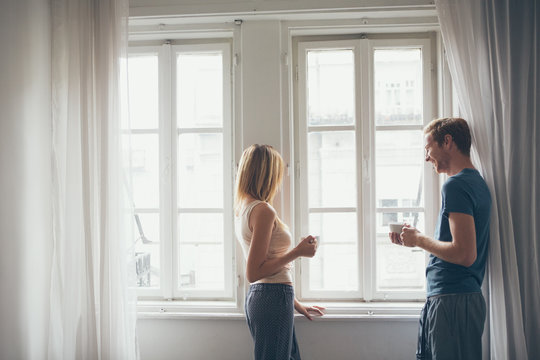 Man And Woman Talking By The Window