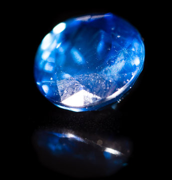 A blue gem on a black background