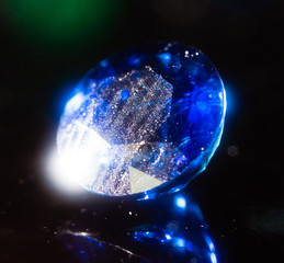A blue gem on a black background