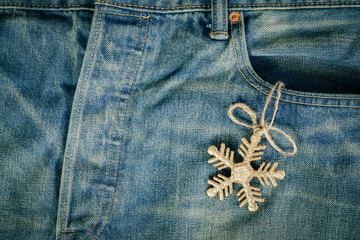  Gold snowflake christmas decoration in old grunge vintage denim jean pocket, christmas fashion background concept