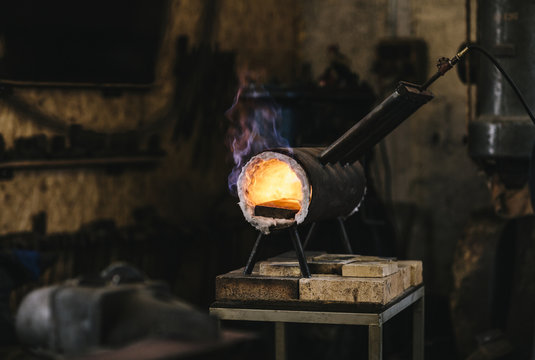 Flames coming out of a blacksmith's gas forge