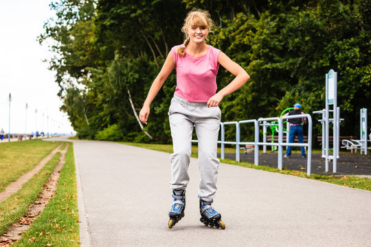 Young female exercise outdoor on rollerblades.