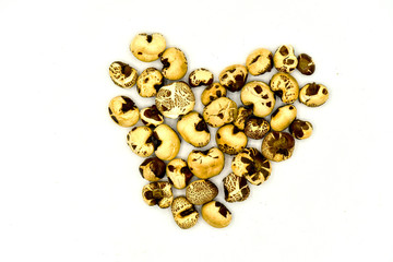 popcorn arranged in a heart shape on white background, popcorn love, organic product,  Popcorn that cares for you 