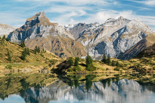 Truebsee  mountain lake with Hahnen and Wissberg mountain peak at Titlis Engelberg in Switzerland at Fall