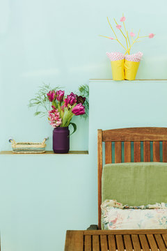 Empty wooden table and chair on bluish background with flowers