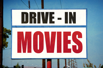 aged and worn vintage drive in movies sign