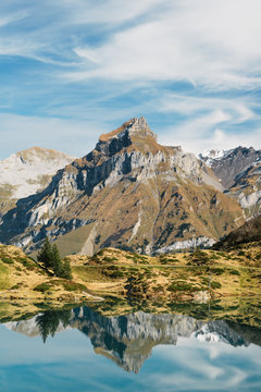 Truebsee  mountain lake with Hahnen mountain peak at Titlis Engelberg in Switzerland at Fall
