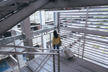 Asian woman passenger in airport, woman travels with luggage