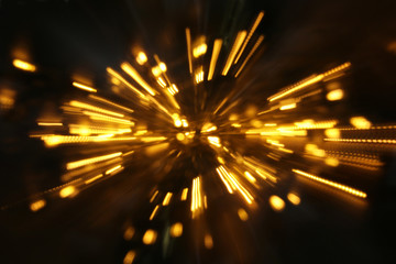 abstract bokeh background of golden light burst made from bokeh motion