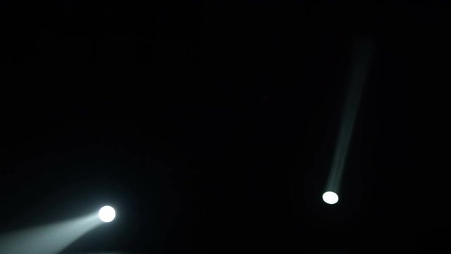 Realistic footage of stage light flashing rays spotlights through smoke. Great as a natural stage background for different projects!!!