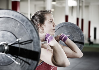 Confident Young Woman Lifting Barbell