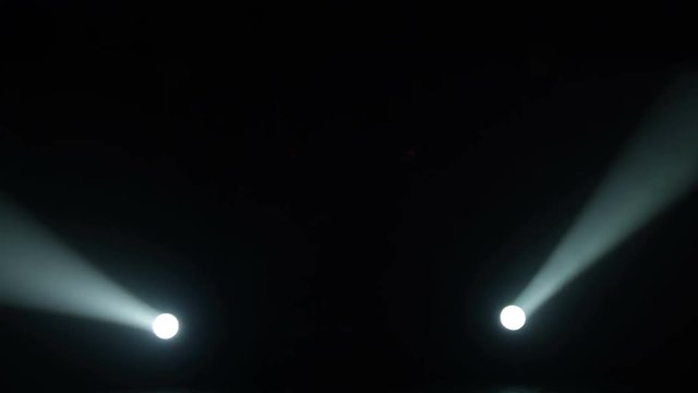 Realistic footage of stage light flashing rays spotlights through smoke. Great as a natural stage background for different projects!!!