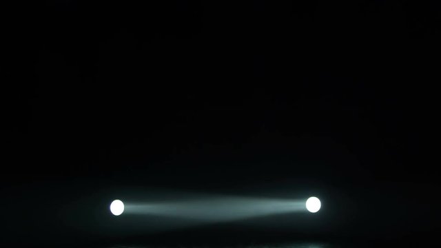Realistic footage of stage light flashing rays spotlights through smoke. Great as a natural stage background for different projects!!!