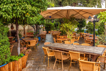Wooden furniture of outdoor cafe in street