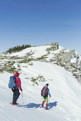Two men climb in the winter in the mountains.