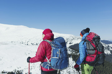 Fototapeta na wymiar Two men climb in the winter in the mountains.