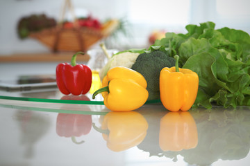 Kitchen interiors. Many vegetables and other meal at glass table are ready for been cooked soon