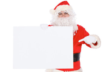 Santa Claus pointing on blank white wall, advertisement banner with copy space. Isolated on white background