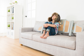 youth little girl sitting on living room couch