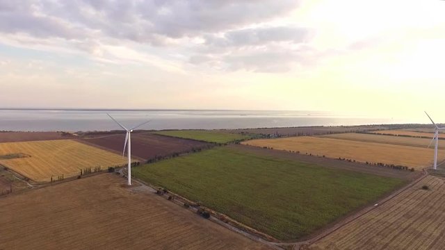 Aerial video of wind power station of giant windmills in works 
