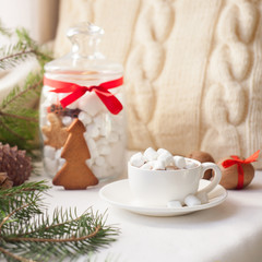 Christmas gingerbread, candy, coffee with marshmallows in white cup, knitted pillow, Xmas holidays background, winter home cozy