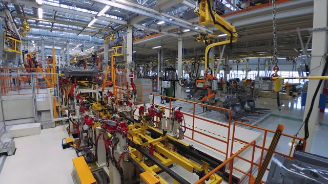 Automobile plant, modern production of cars, car body assembly process, automated production line. Timelapse.
