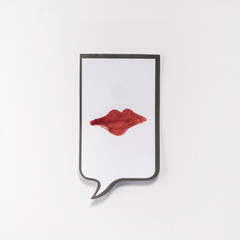 a white memo pad with the shape of a comic with the red lips