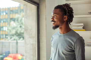 Smiling African Looking out of the Window
