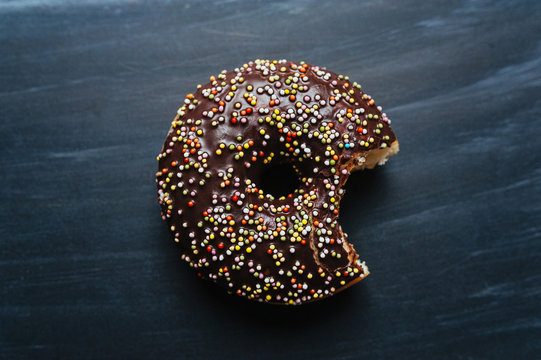 Donut with Chocolate Icing and Colorful Sprinkles