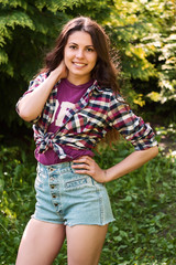 Fototapeta premium Girl in shorts and a shirt in a cell