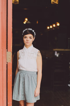 Girl in a skit in the doorway of a restaurant