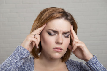 Naklejka premium Studio portrait of redhead girl with hair Bob and emotion pain in the head