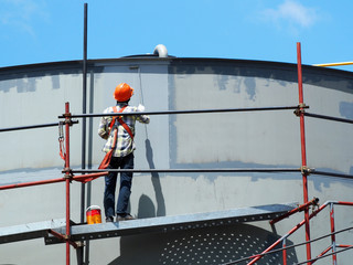 Construction workers working on scaffolding, Man Working on the Working at height with blue sky at construction site