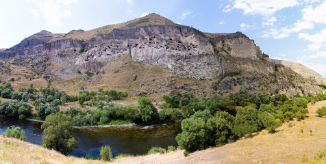Ancient cave city in Georgia and the river Kura. © Alexander