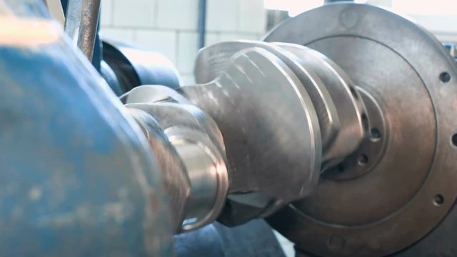 Close up of grinding of crankshaft on a grinding machine. Shot with Sony a7s and Atomos Ninja Flame on tripod in car service.