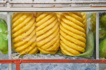 fruit such as pineapple ,mango are in glass cabinet on Mobile sales vehicles. female trader style  in Thailand. 