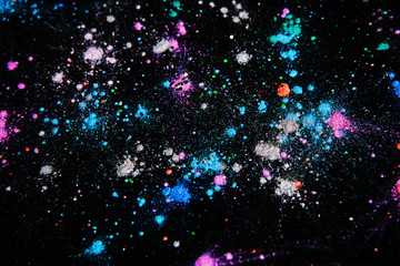 Colorful powdery space star splashes, galaxy concept, top view. Professional abstract pigment...