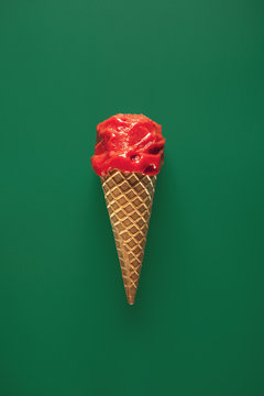 Strawberry ice cream on green background. Overhead.