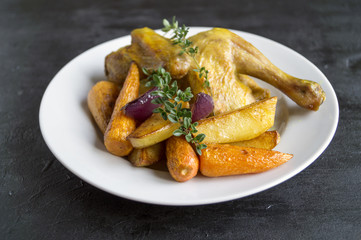 Roasted chicken with carrots and thyme.